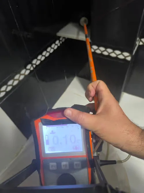 Detector de fugas de agua funcionando junto a una tubería en una vivienda